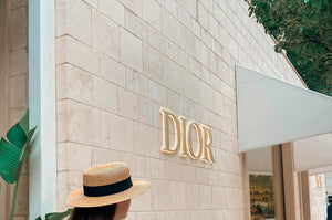 A female walking past a dior stores