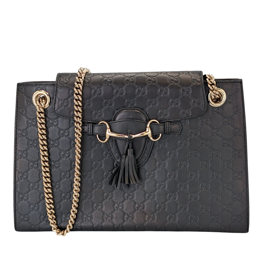 Secondhandbags AG black Guccissima leather shoulder bag with embossed GG motif, gold hardware, and tassel detail.